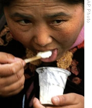 A Tibetan woman tries some yogurt during a yogurt festival in Lhasa