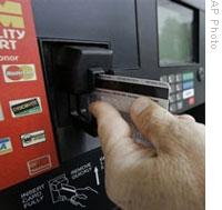 A motorist uses a credit card to buy gasoline in Morgantown, North Carolina