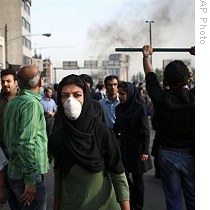 In this photograph posted on the internet, an Iranian woman wears a mask near an anti-government protest in Tehran, Iran, 20 Jun 2009