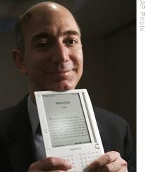 Jeff Bezos, founder and CEO of Amazon.com, holding a Kindle device