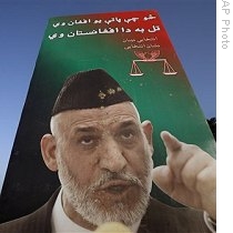 A poster of President Hamid Karzai, who is also a presidential candidate is seen defaced with mud in Kabul, Afghanistan, 09 Aug 2009