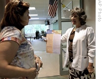 Nurse Cindy Womack talks to teacher Chritine Quint about ways to prevent the H1N1 flu virus at their school in Houston, Texas