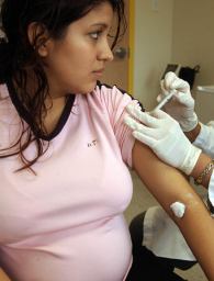 File photo of a pregnant woman receiving a seasonal flu shot in Dallas, Texas